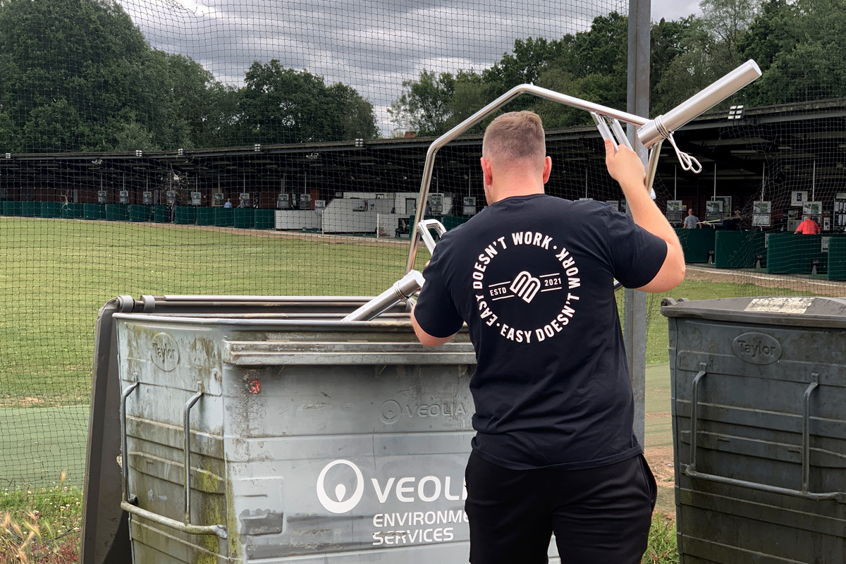 Jon throwing a Trap Bar in the recycling bin